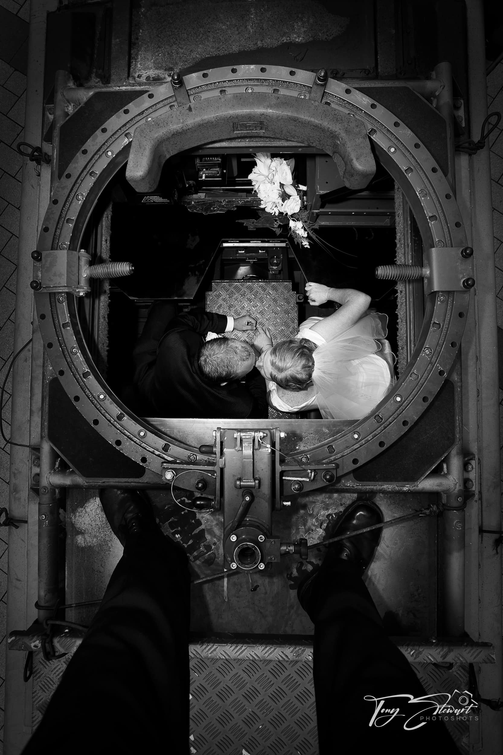 Bridal couple kiss, seen looking down through the turret of an Army LAV.