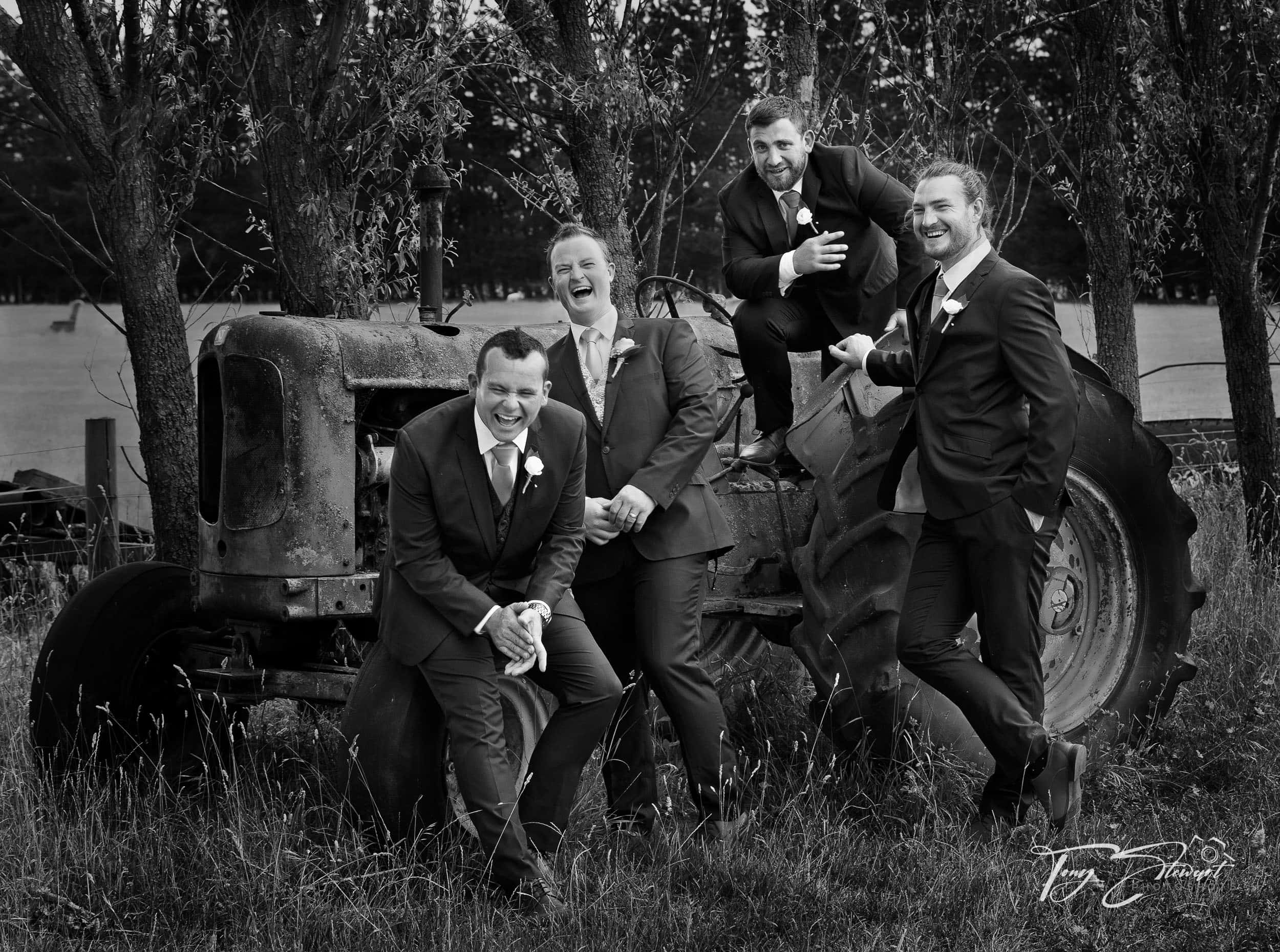 Groomsmen have a good laugh seated on farm tractor in Loburn, North Canterbury.