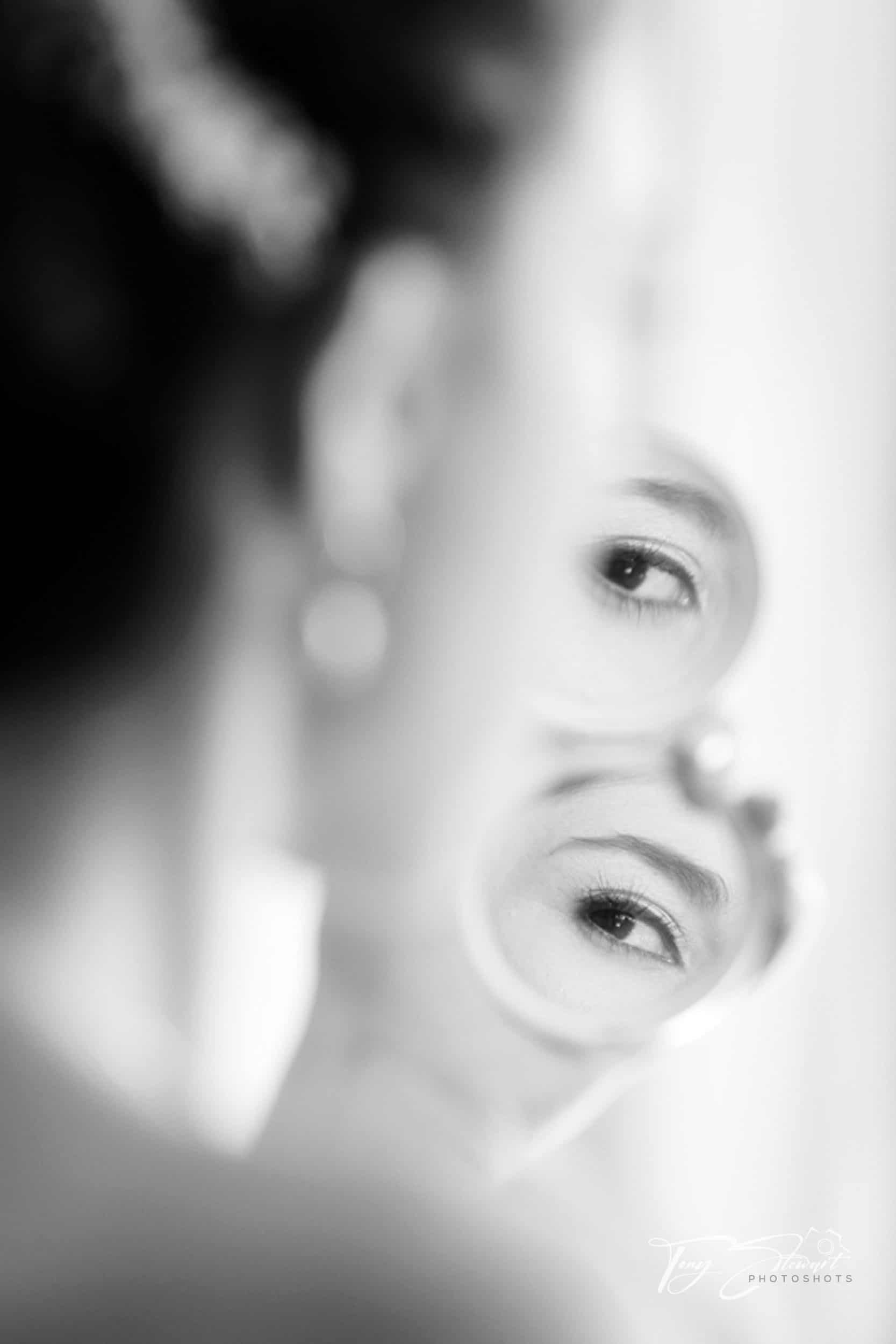 Bride's eye reflected in make up compact.