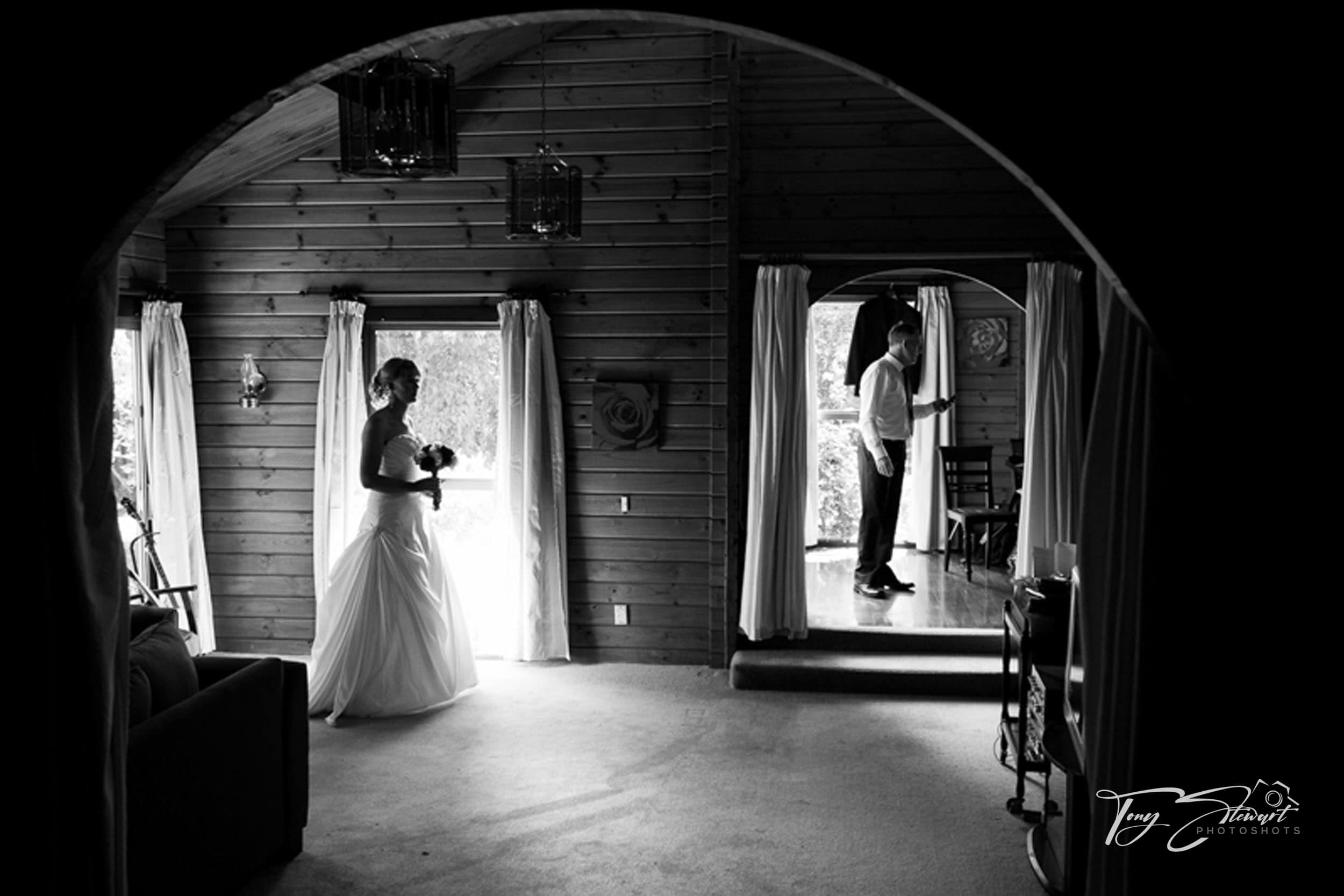 Nervous bride prepares to leave log cabin to head to her garden wedding.