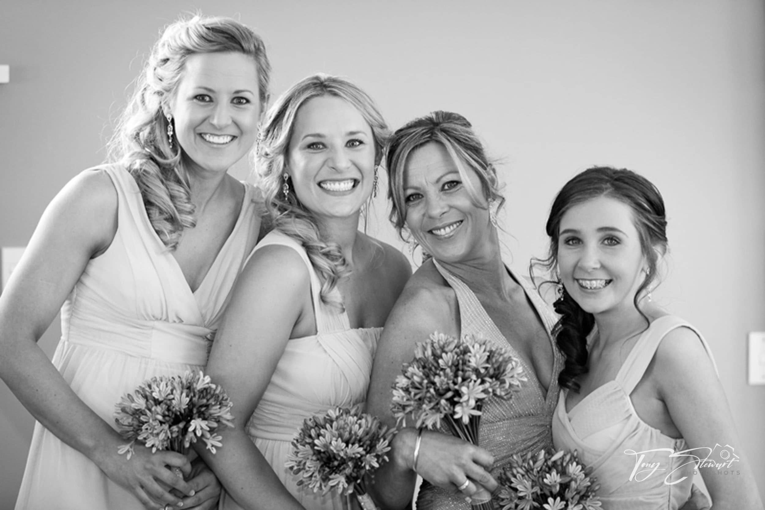 Bridesmaids pose together with their Mum, before leaving for their Mum's wedding ceremony.