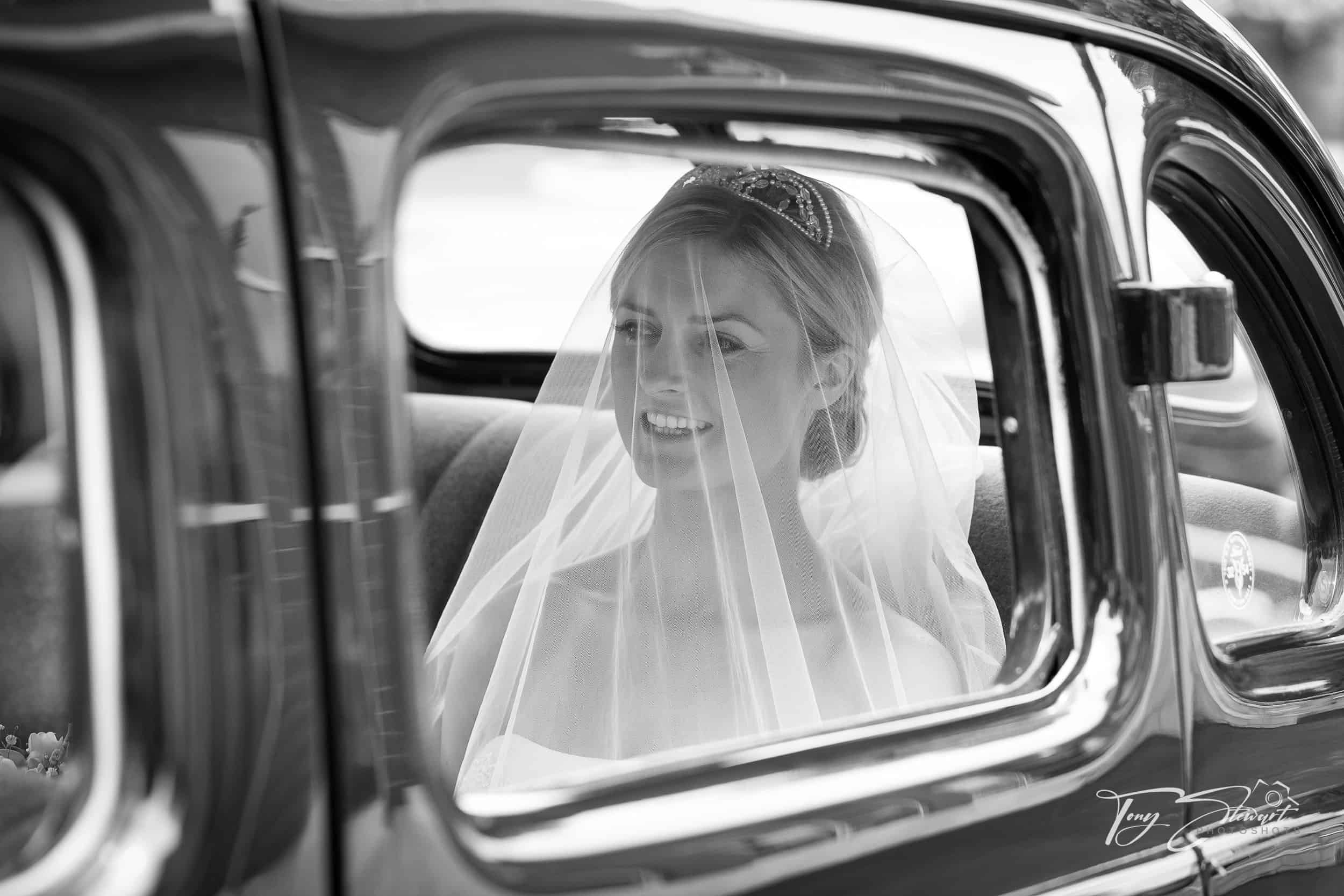 Bride gets ready to leave for church in her Dad's vintage car.