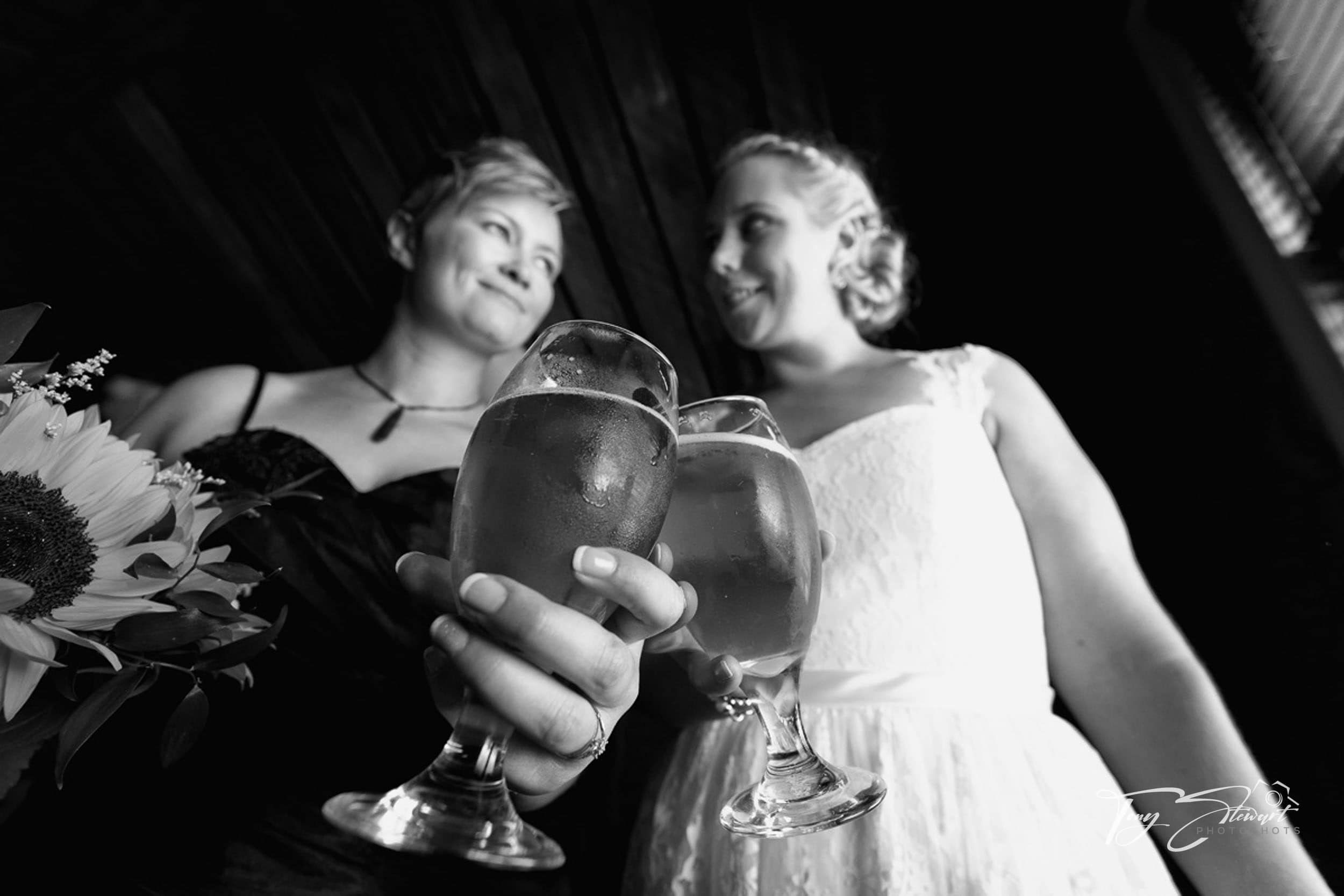 Two brides share a beer at The Laboratory in Lincoln.