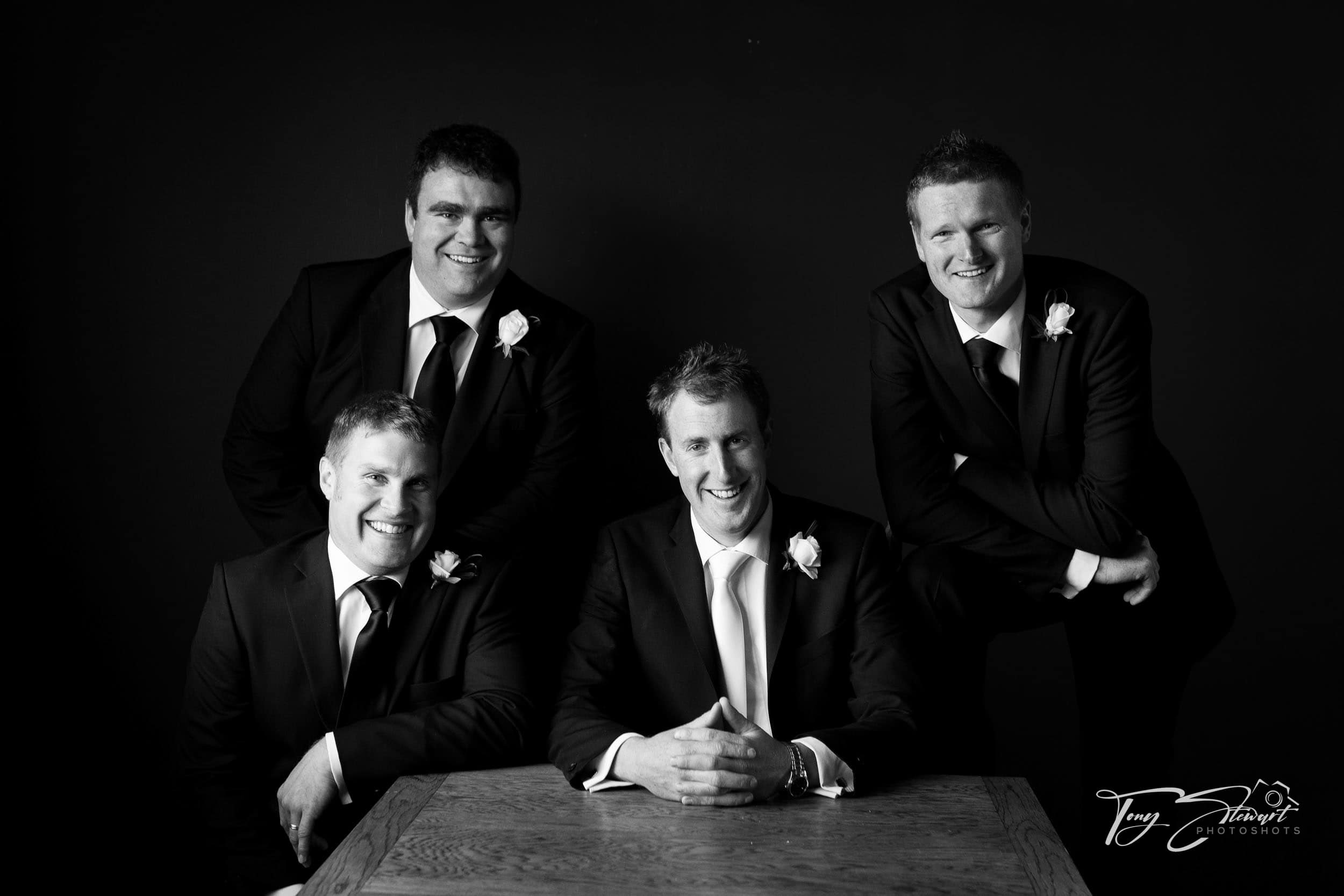 Lads pose with happy groom.